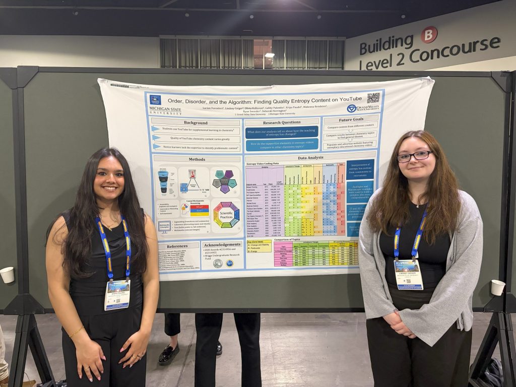 Image of 2 students in front of a scientific poster